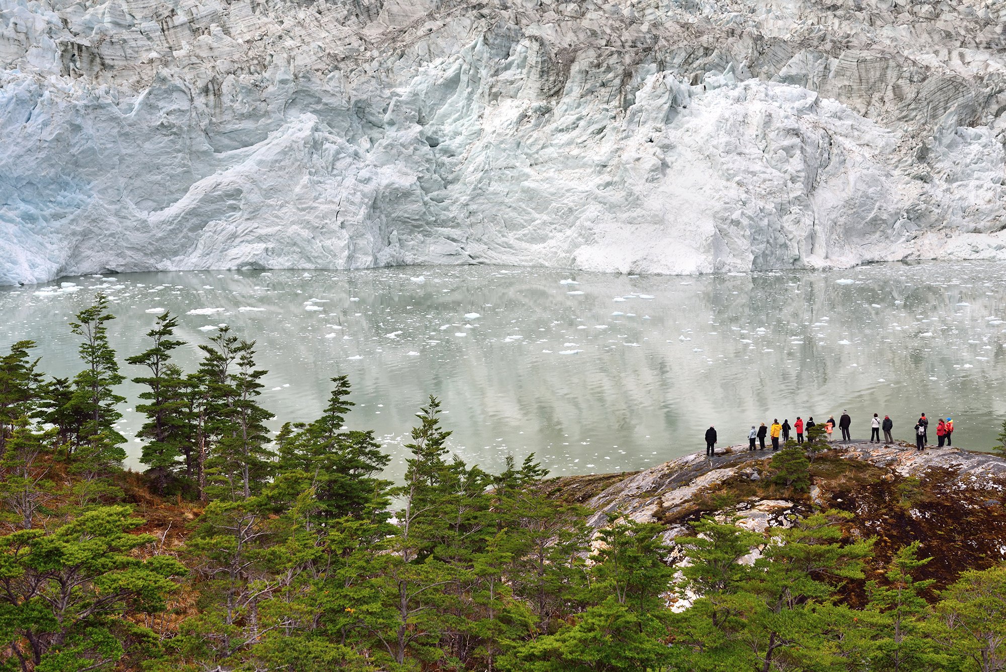 Grupo de excursionistas parados frente al glaciar Pía en Patagonia